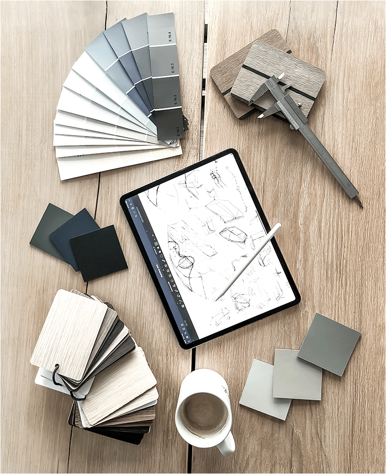 Creative process - color palettes, material samples, coffee, caliper and tablet with sketches